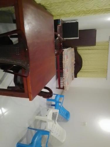a desk with a telephone and blue plasticclips at Namal Vacation House in Kegalle