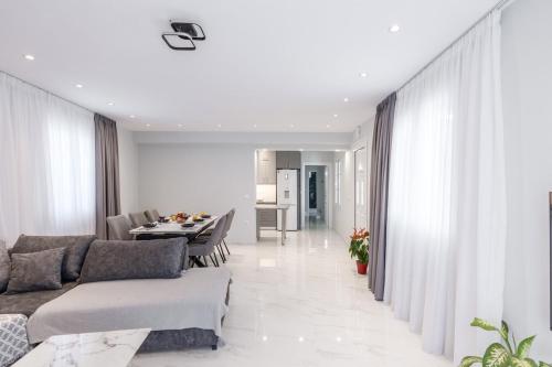 a living room with a couch and a table at Villa Amantia in Kouvaláta