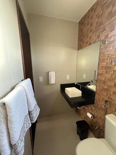 a bathroom with a sink and a mirror at Nosso Chalé in Serra de São Bento
