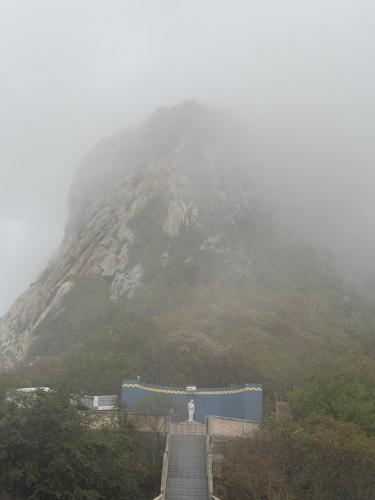 a mountain with a gate and a statue in front of it at Hotel Rainha do Sertão By Lmm in Quixadá