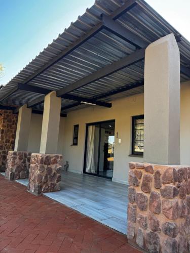 a building with awning on the side of it at Welgedacht Lodge in Cullinan