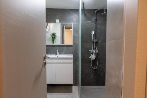 a bathroom with a sink and a shower at Terra Nobile, 3BR Mountain Stone Escape BBQ Fireplace in Galataria