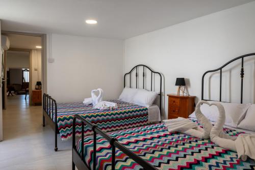 a bedroom with two beds with towels on them at Terra Nobile, 3BR Mountain Stone Escape BBQ Fireplace in Galataria