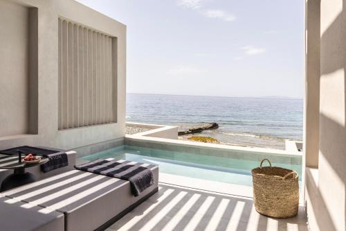 a balcony with a view of the ocean at Orion Tinos Suites in Vrachonisída Chántra
