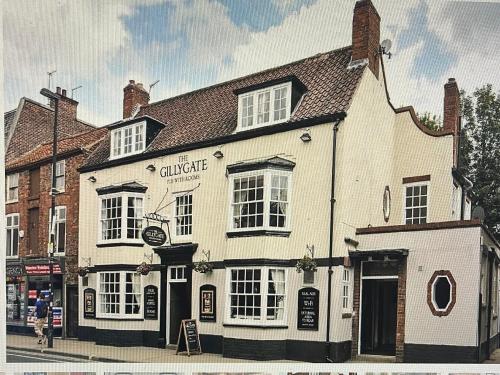 a white building on the corner of a street at The Gillygate Inn in York