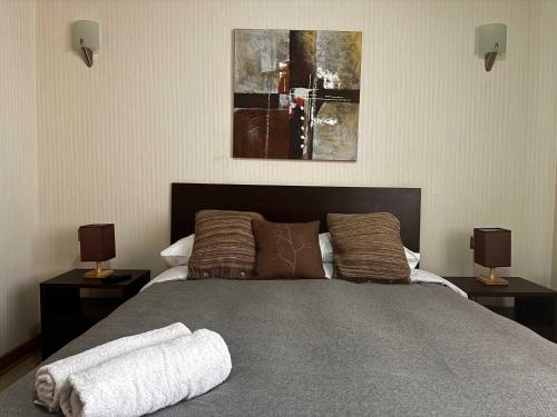 a bedroom with a large bed with two night stands at HOM I 6PAX Edificio Valle Cóndores SKI OUT Valle Nevado in Santiago