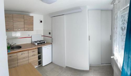 a kitchen with white cabinets and a white refrigerator at Willa Kasper in Świnoujście