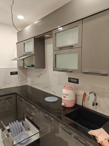 a kitchen with a sink and a counter top at Olive Retreat in Guwahati