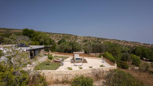 an aerial view of a garden with a stone wall at Thea Estate in Kritou Terra