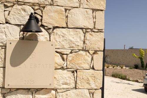 a light on the side of a stone wall at Thea Estate in Kritou Terra
