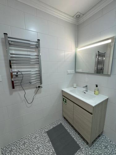 a bathroom with a sink and a mirror at Ponto de vista in Angra do Heroísmo