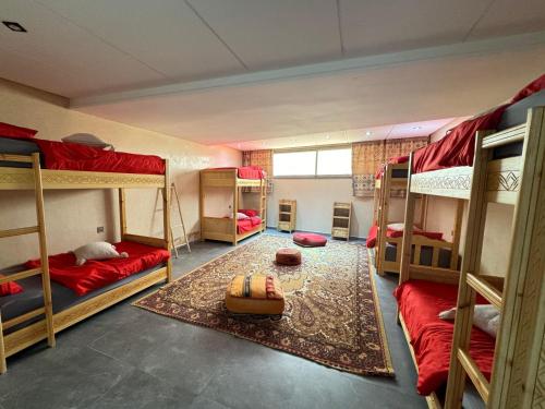 a room with four bunk beds in it at surf house Agadir in Tama ou Ennza