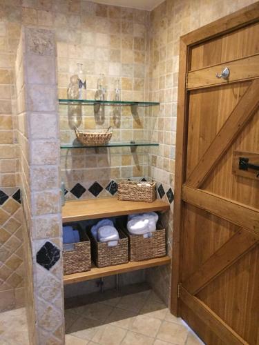 a bathroom with a closet with a wooden door at The Apple Shed in Farmborough