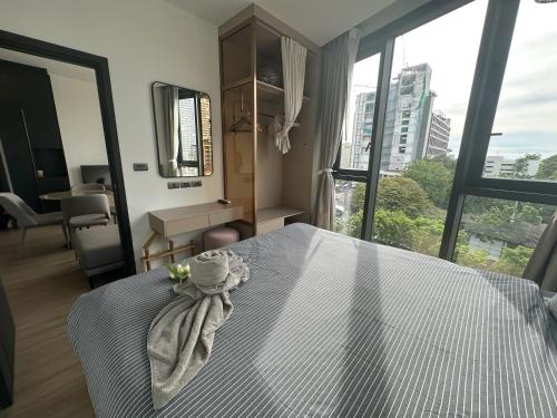 a bedroom with a bed with a towel on it at The Edge central pattaya in Pattaya Central