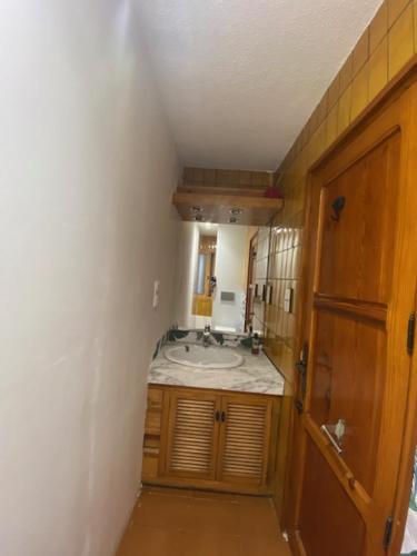 a bathroom with a sink and a mirror at Pink Lemon House in Elche