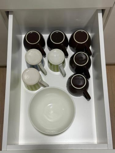 a white plate in a drawer with a bowl and other utensils at Mama King’s Homestay@ Palas Horizon in Brinchang