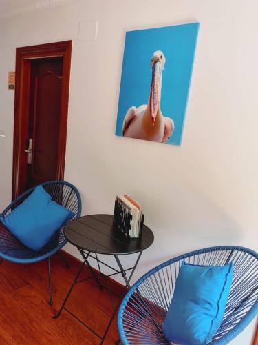 a room with a table and chairs and a picture of a man at Casa MARIO y MARIOLA in El Dueso