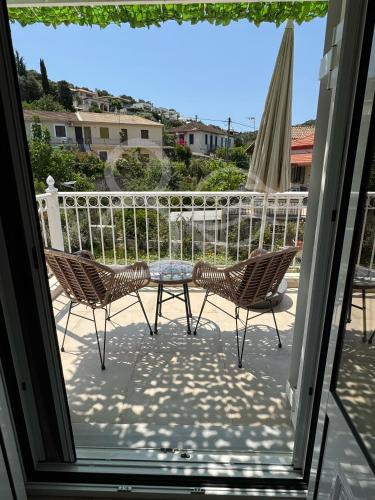 a patio with two chairs and a table on a balcony at 8 Homes in Meganisi