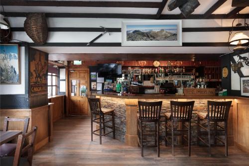 a bar in a restaurant with stools at Climbers Inn in Glencar