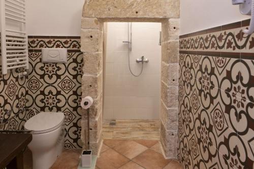 a bathroom with a shower and a toilet in it at Masseria Luci Grande in Scorrano