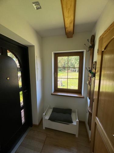 a room with a window and a bench in a room at Czar Roztocza in Hamernia