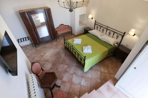 an overhead view of a bedroom with a green bed at Masseria Luci Grande in Scorrano