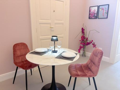 a table with two chairs and a lamp in a room at Luxury Suite - Free WifI - Smart Tv - centro Storico in Mesagne