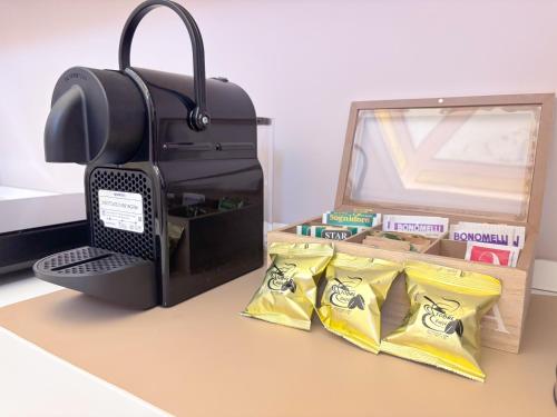a bag of potato chips next to a box of chips at Luxury Suite - Free WifI - Smart Tv - centro Storico in Mesagne