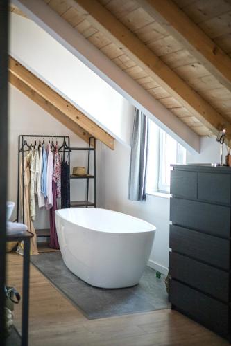 a bathroom with a large white tub in a room at Studio apartments Yucca, 2-min to the beach and 5 to Trogir in Trogir