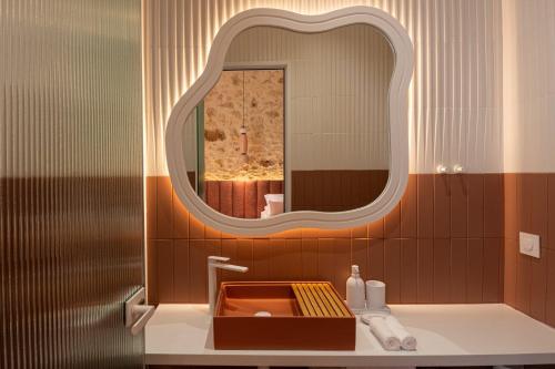 a bathroom with a sink and a mirror at Madonna del Mare City in Chania Town