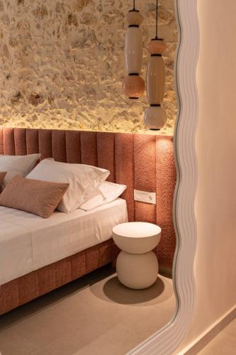 a bedroom with a bed with a mirror on the wall at Madonna del Mare City in Chania Town