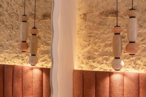 a room with a mirror and four chandeliers at Madonna del Mare City in Chania Town