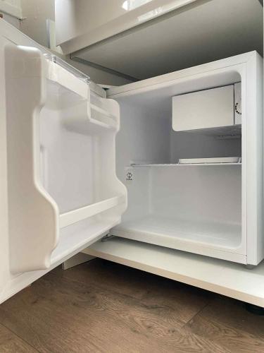 an empty white refrigerator with its door open at Studio Bareges Le Rioulet 1 in Barèges