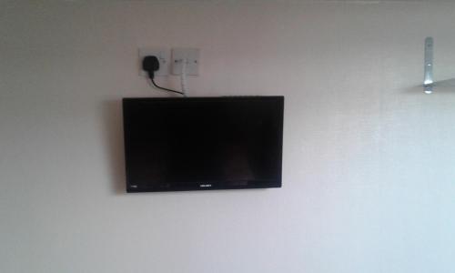 a flat screen tv hanging on a wall at Strides Hotel in Blackpool