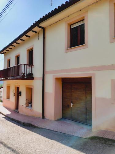 a house with two garage doors on the side of it at Casa MARIO y MARIOLA in El Dueso