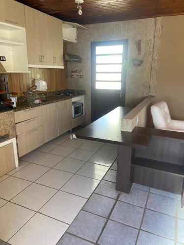 a kitchen with a table in the middle of it at Sobrado 263 in Jaguarão