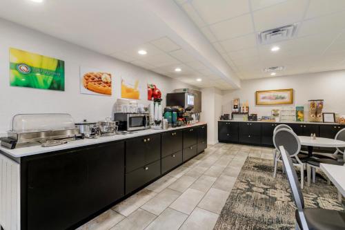 a large kitchen with black cabinets and a table at Quality Inn Eureka Springs South in Eureka Springs