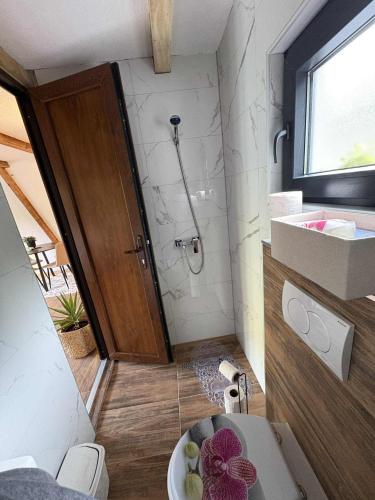 a bathroom with a toilet and a sink and a shower at Vikendica Hamza in Bihać
