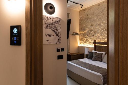 a bedroom with a bed and a picture of a woman at Madonna del Mare City in Chania Town