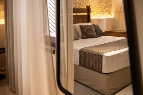 a bedroom with a bed and a mirror at Madonna del Mare City in Chania Town