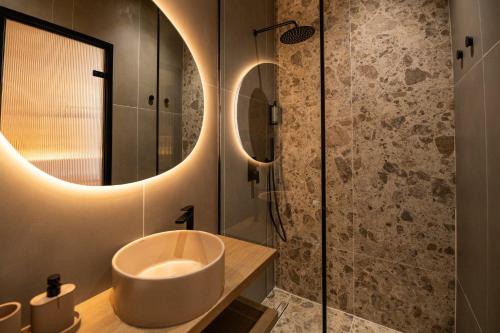 a bathroom with a white sink and a mirror at Madonna del Mare City in Chania Town