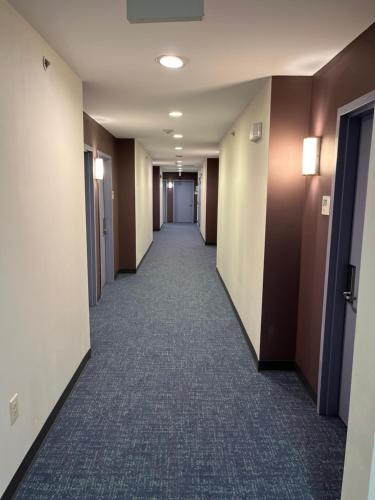 a hallway of an office building with a long corridor at Tapa Hotel, Inn & Suites in Mahwah