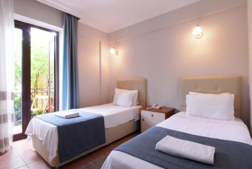 Postel nebo postele na pokoji v ubytování Villa Danlin Hotel