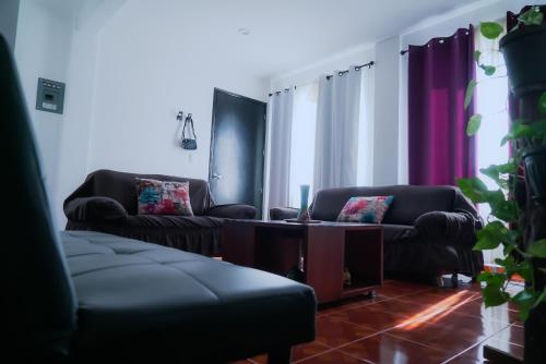 a living room with two couches and a table at Departamentos "GARCÍA LÓPEZ" es amplio muy acogedor 2 dormitorios y cerca del Auditorio Guelaguetza in Oaxaca City