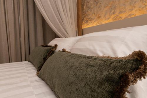 a close up of a bed with a pillow on it at Madonna del Mare City in Chania Town