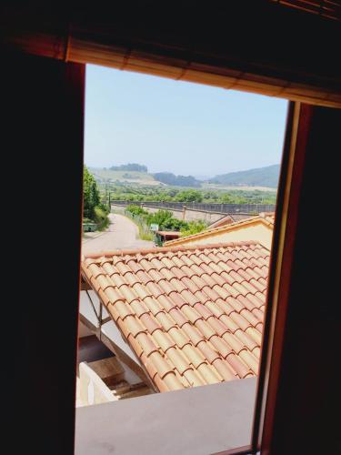 a view of a tile roof from a window at Casa MARIO y MARIOLA in El Dueso