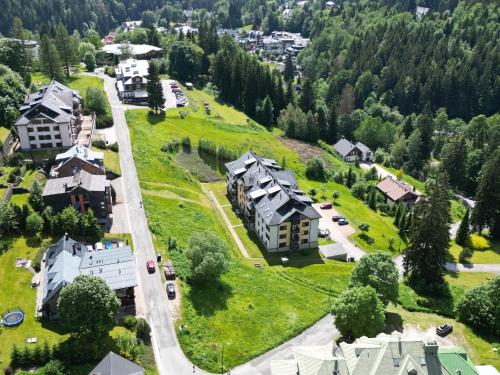 an aerial view of a village with houses and trees at Apartmán Špindl 101čka Dalibor II in Špindlerův Mlýn