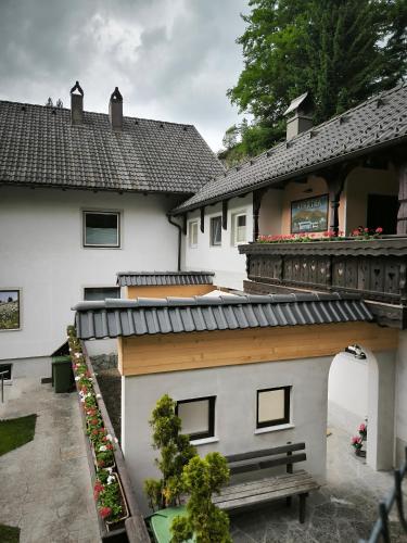 a house with a balcony and a bench in front of it at Apartment Tarman in Jesenice