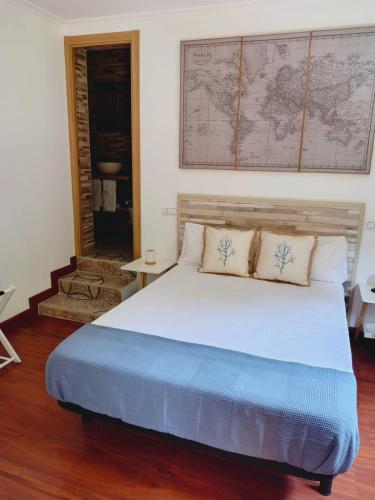 a bedroom with a large bed with a map on the wall at Casa MARIO y MARIOLA in El Dueso