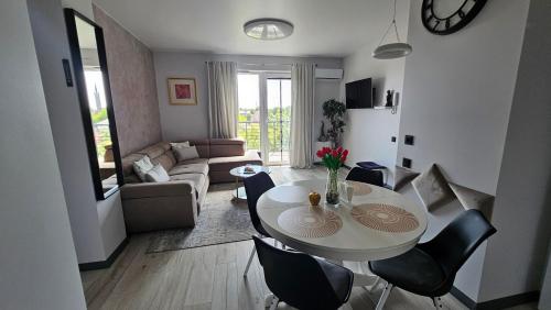 a living room with a white table and chairs at AA Apartments OldTown in Klaipėda